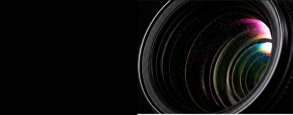 Close-up of a camera lens showing fine internal dust under inspection lighting